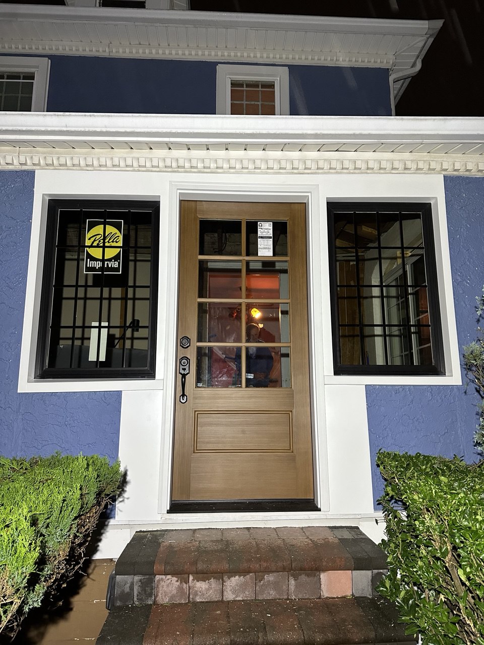 Entry door with sidelights on blue house